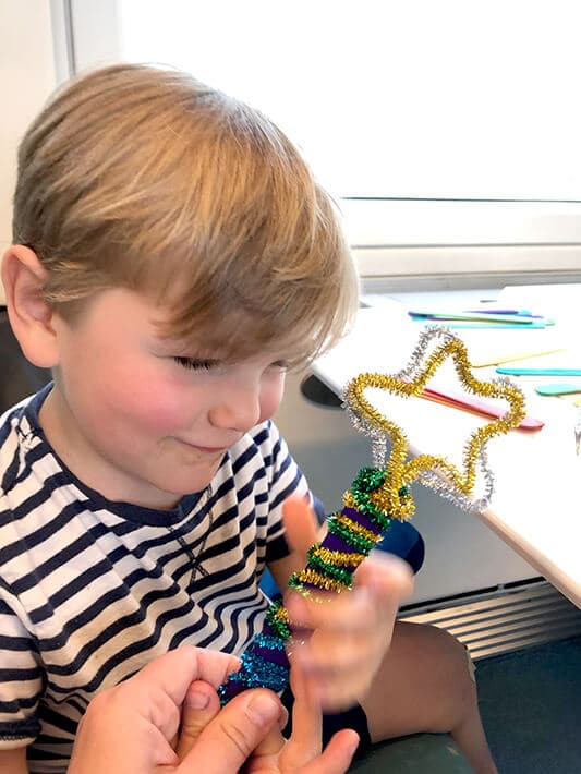 Traveling with toddlers – boy with star wand made out of pipe cleaners