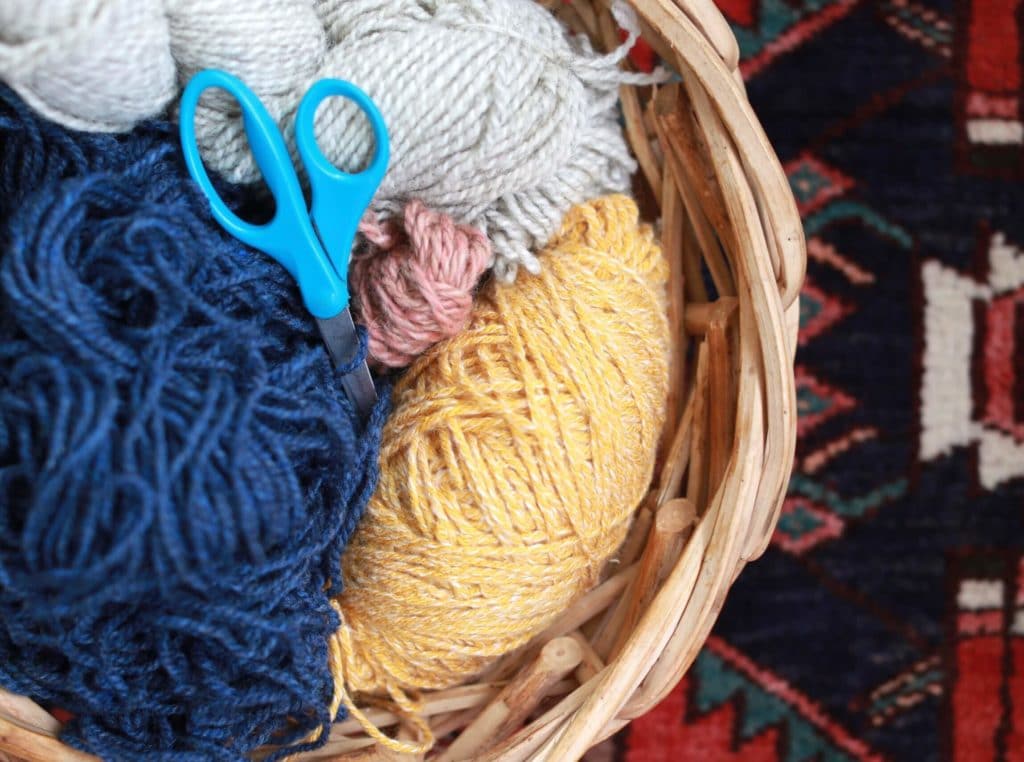 Scissors and a basket of yarn