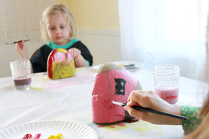 Children painting rock houses for kids