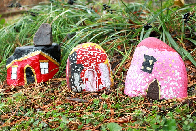 Three painted rock houses for in grass
