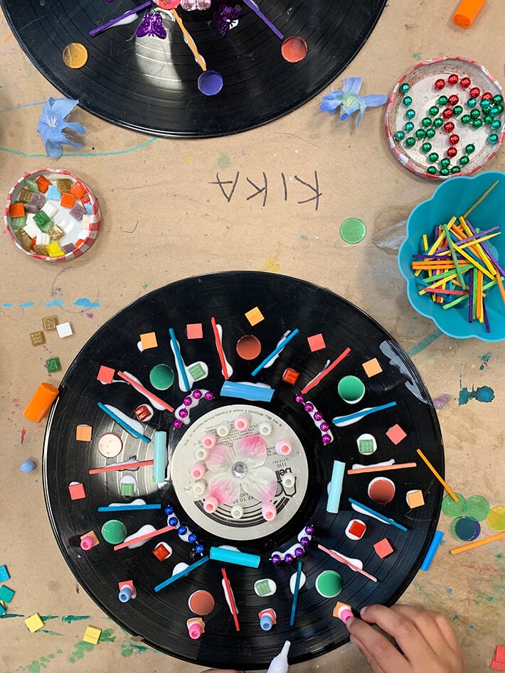 Child creating record mandala with loose parts