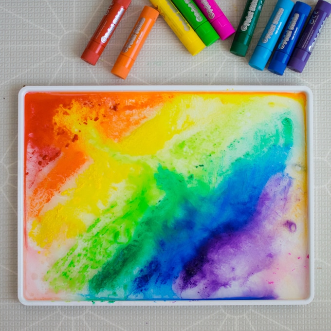 Rainbow ice painting with tempera paint sticks by Inspire My Play