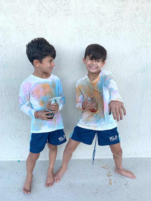 Boys-with-painted-white-shirts-with-squirt-bottles-of-paint