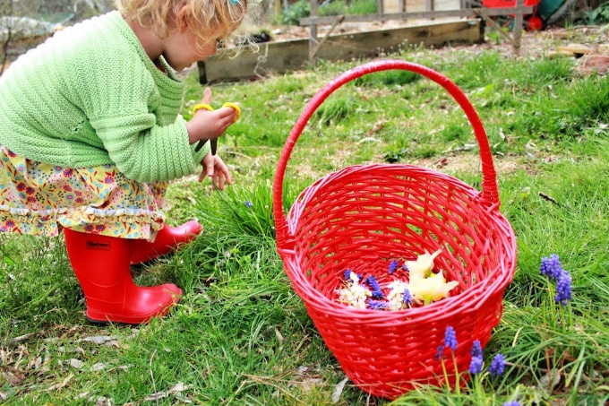 Young child gathering nature items in a basket — Activity Craft Holidays, Kids, Tips
