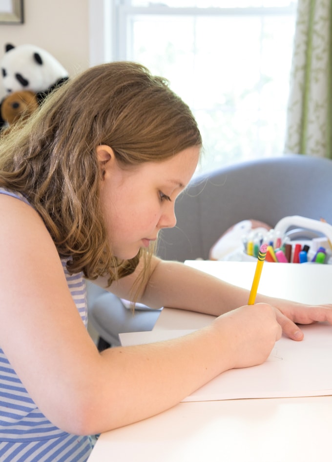 Child drawing at desk