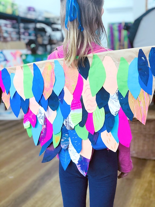 Girl wearing handmade paper wings