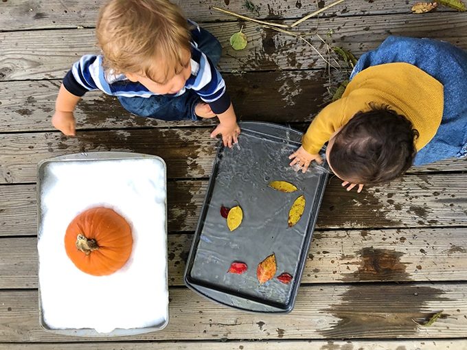 Foamy water play with pumpkin and floating leaves – fall sensory play activities for kids.