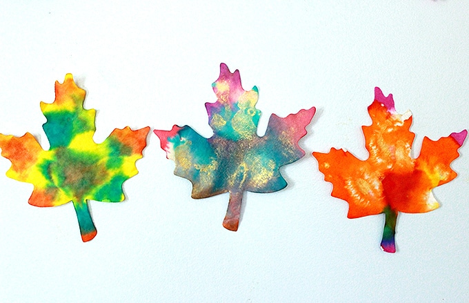 Three painted fall paper leaves