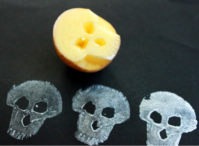 Skull shaped Halloween potato and three prints