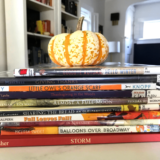 Stack of seasonal books with pumpkin