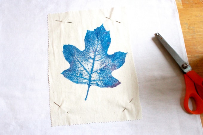 Leaf print on fabric with scissors