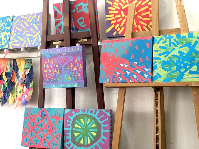 Geometric art with tape resist displayed on easels.