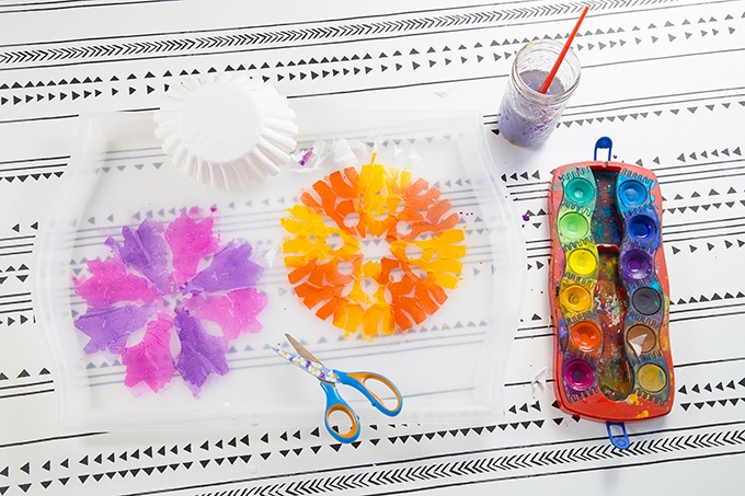 Paint coffee filter snowflakes with watercolors.