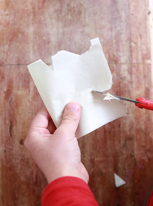 Child cutting tissue paper for Mexican folk art