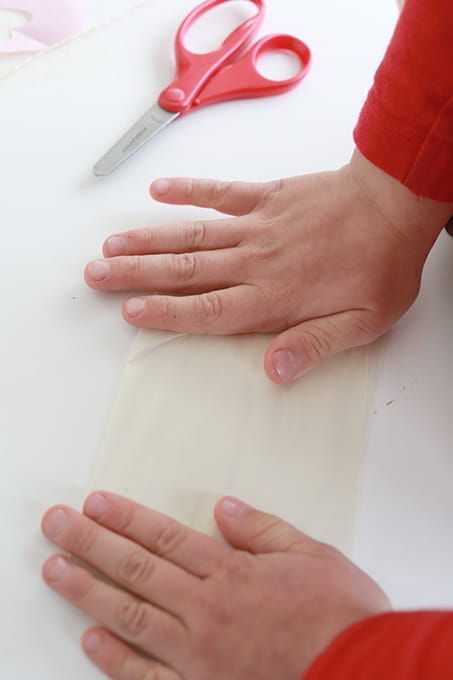 Child folding tissue paper
