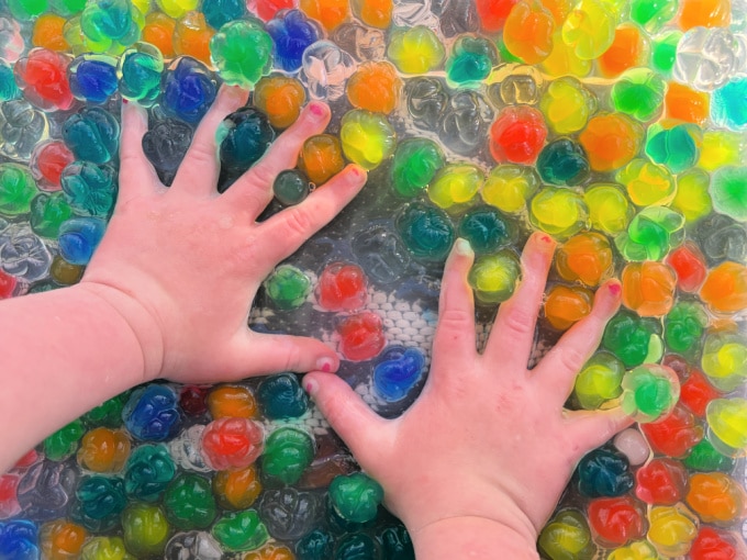 hands in water beads