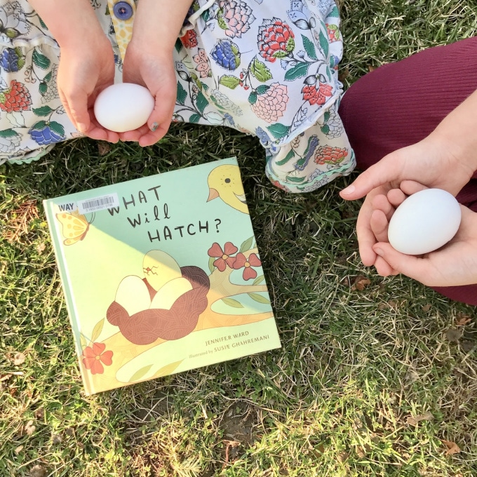 children sitting with eggs and What Will Hatch book