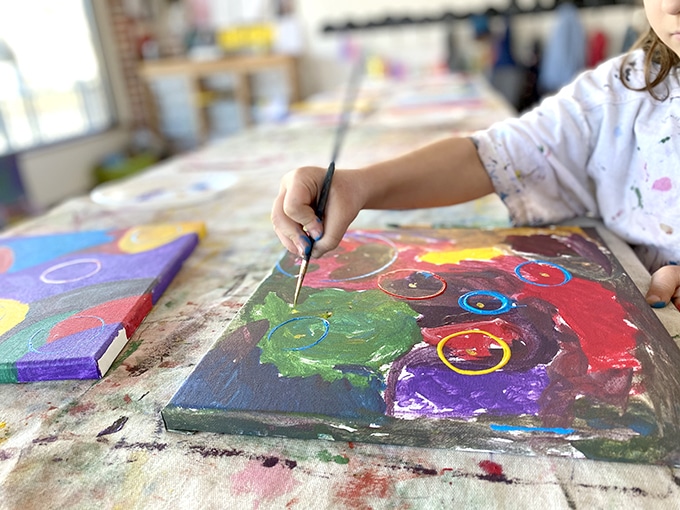 Child painting on canvas