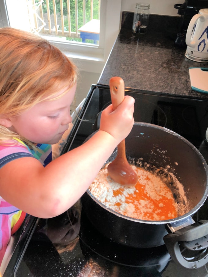 stirring orange playdough on stove_andrea martelle