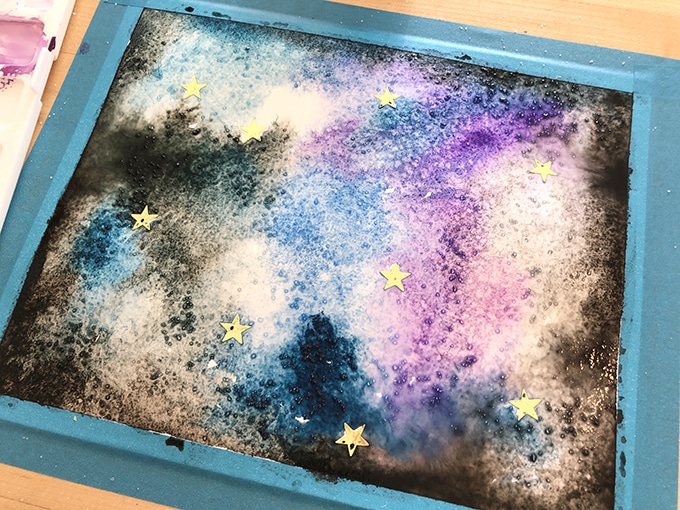 Galaxies space art with watercolors and sticker resist
