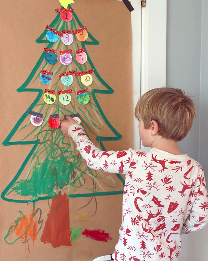 child painting christmas tree on paper