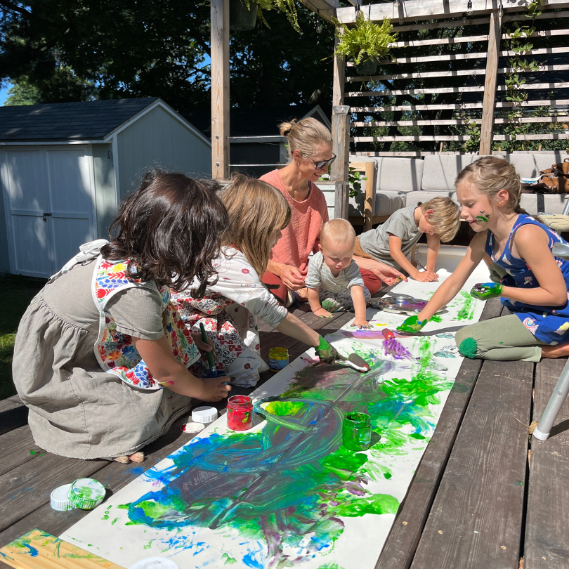 group of children painting mural