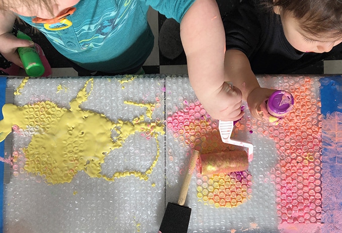 kids rolling and painting bubble wrap
