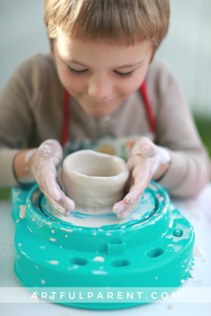 child creating pot on kids pottery wheel_pin
