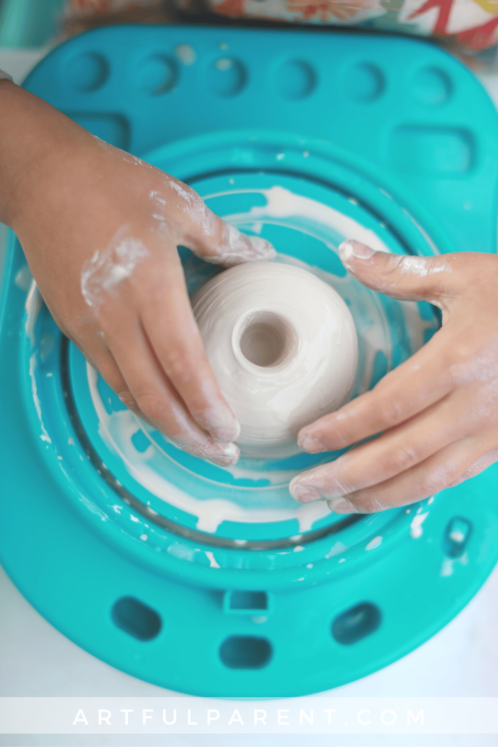 opening a pot on kids pottery wheel_pin
