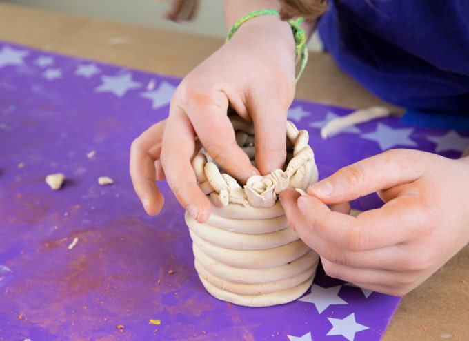 forming a rose on clay pot