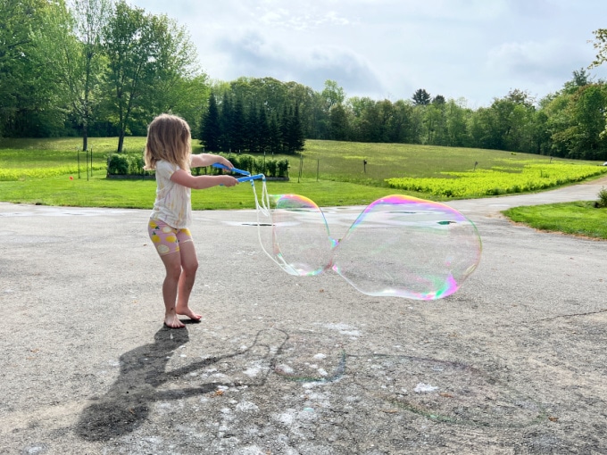 girl making big bubbles