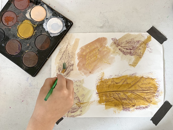 child-painting-leaf-rubbings