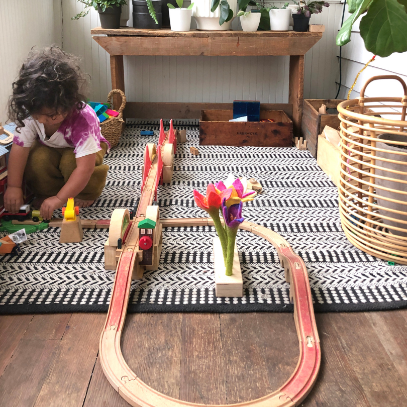 child playing with train