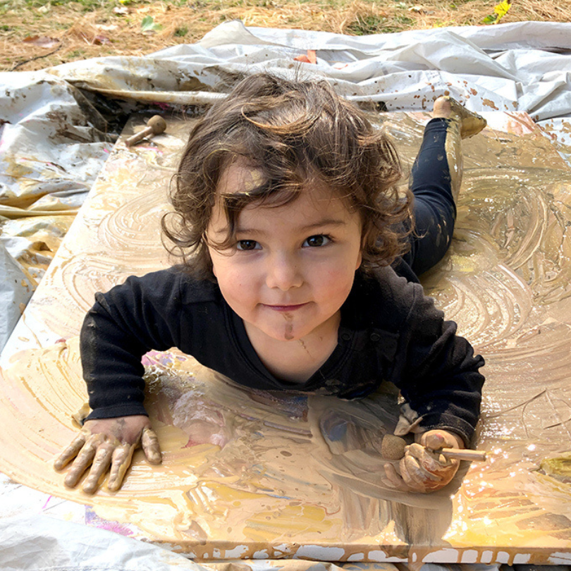 baby painting outside