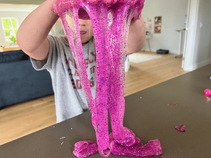 child playing with glitter slime