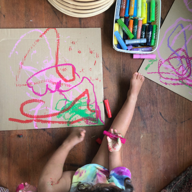 toddler drawing on cardboard