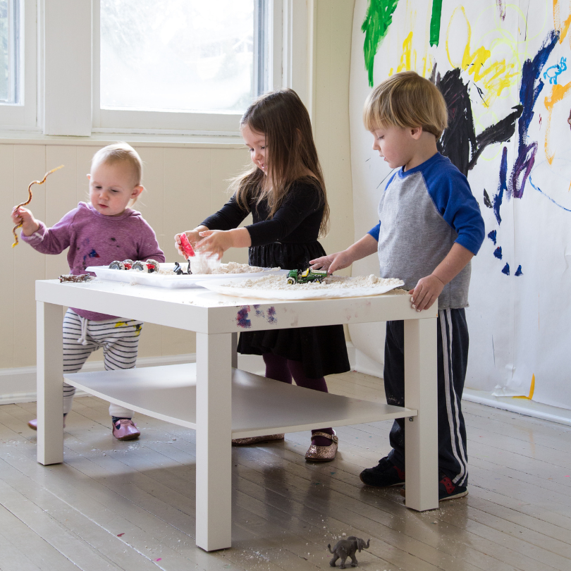 toddlers working at table