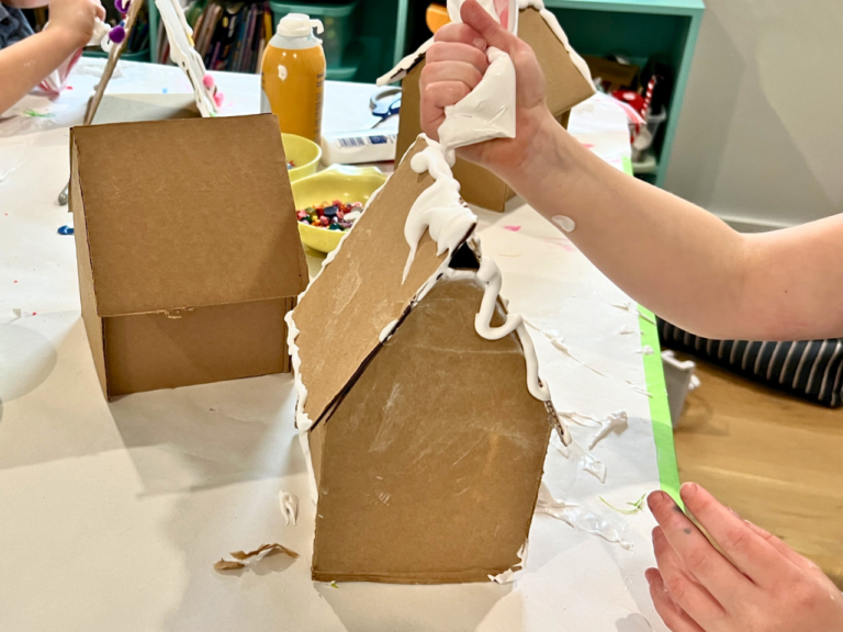 adding frosting to cardboard houses