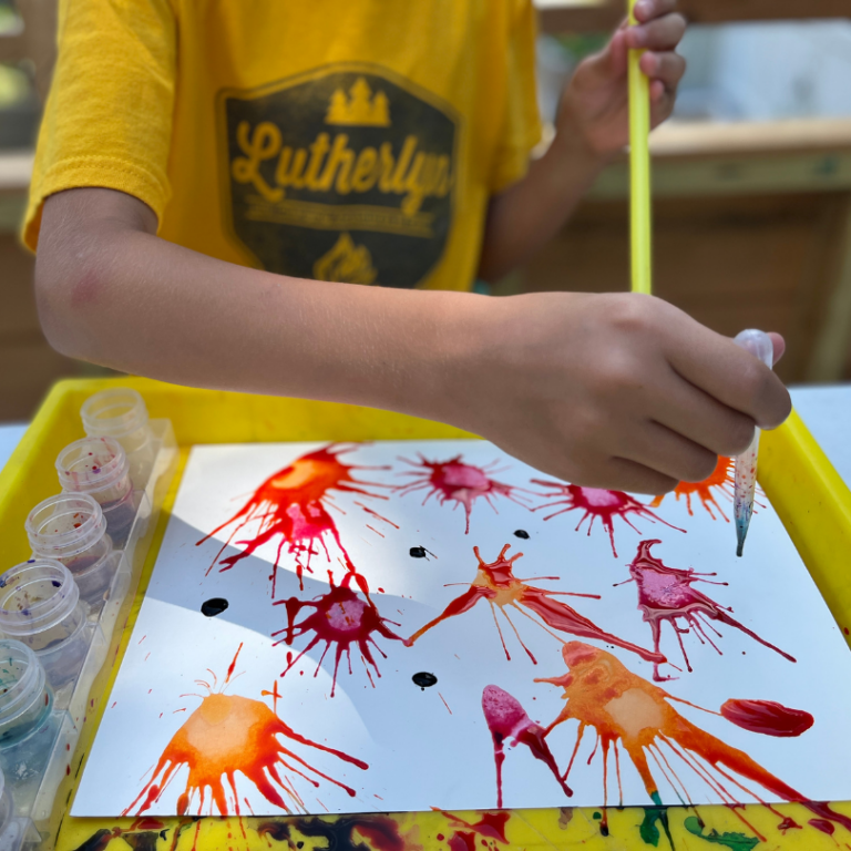 adding paint to blow painting