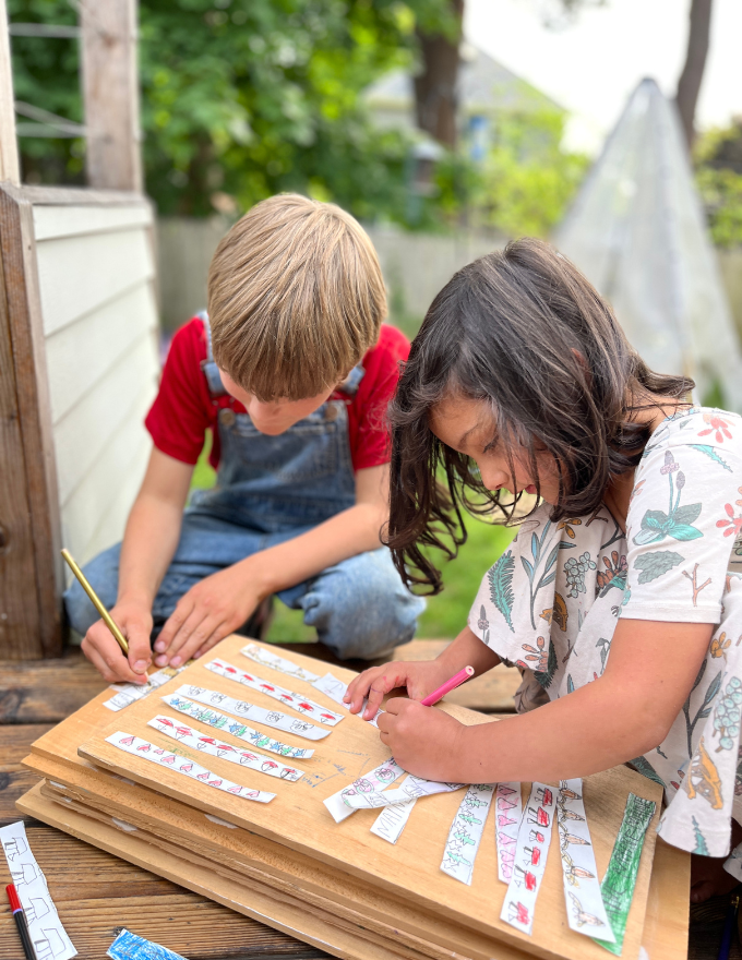 kids drawing designs on paper chains