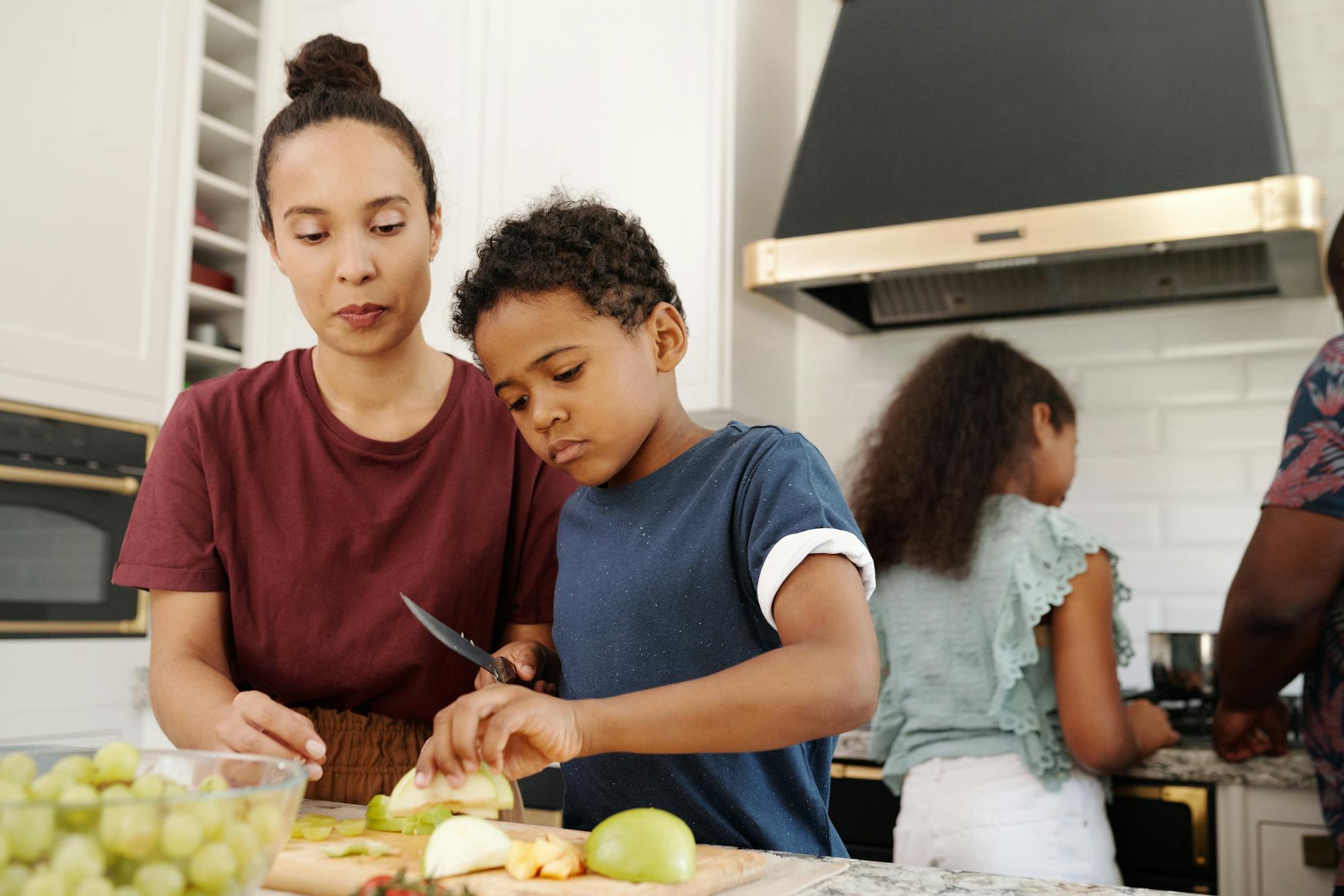 A family enjoys quality time preparing food together in a cozy kitchen setting.