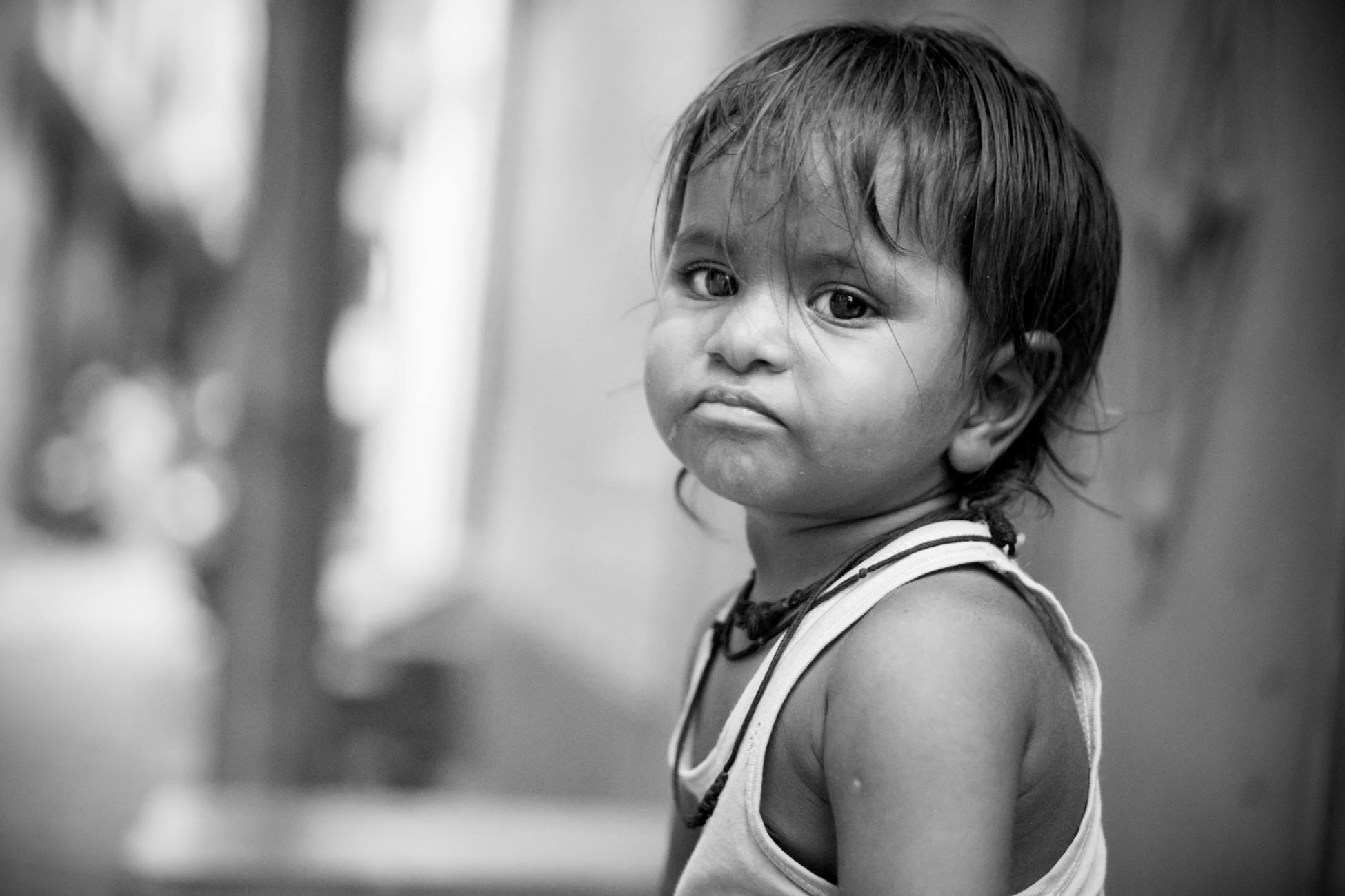 Heartfelt black and white portrait capturing a sad toddler's expression.