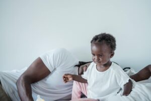 A heartwarming scene of a father and daughter sharing a moment of love and closeness indoors.