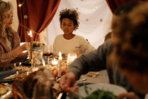 A warm family gathering around a candlelit dinner table, highlighting togetherness and joy.