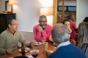 A family enjoying a casual meal indoors, sharing food and conversation.