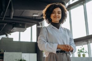 A confident businesswoman smiling in a modern office environment