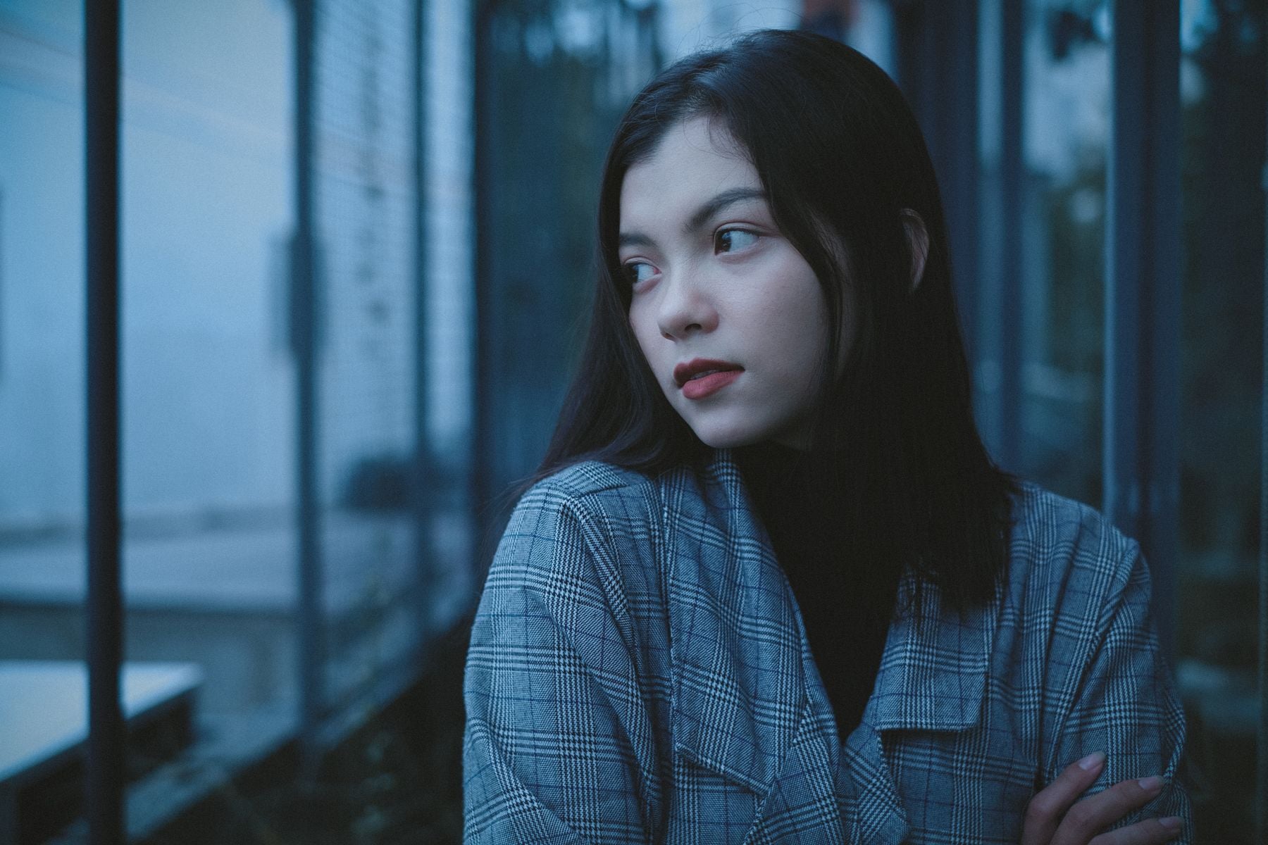 A young person with a thoughtful, serious expression