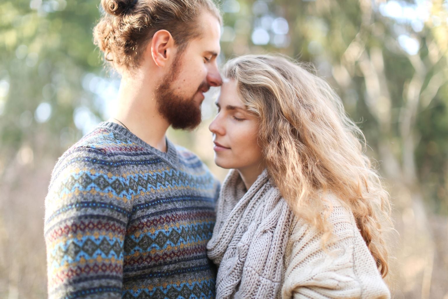 A couple embracing warmly in soft light.