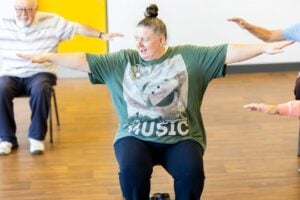 A group of elderly people exercising together.