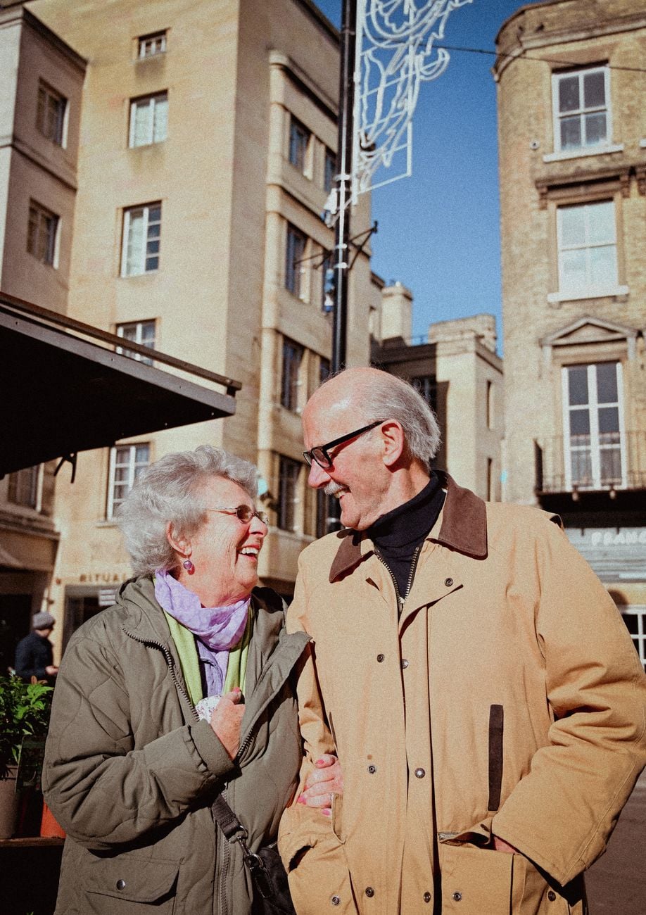 An elderly couple enjoying a sunny day together outdoors.